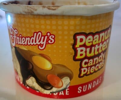 VANILLA FLAVOR ICE CREAM TOPPED WITH FUDGE, PEANUT BUTTER SAUCE & REESE'S PIECES CANDIES, VANILLA