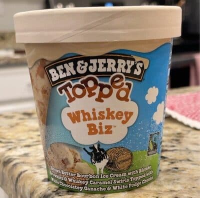 TOPPED WHISKEY BIZ BROWN BUTTER BOURBON ICE CREAM WITH BLONDE BROWNIES & WHISKEY CARAMEL SWIRLS TOPPED WITH WHITE CHOCOLATEY GANACHE & WHITE FUDGE CHUNKS, TOPPED WHISKEY BIZ